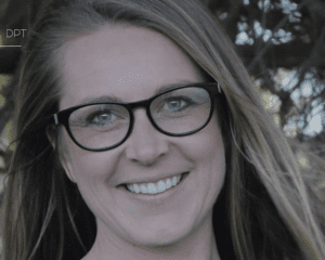 A woman with long light brown hair and black glasses smiles outdoors. She is in front of greenery, and the letters DPT—hinting at a Sales Page Template—are faintly visible in the top left corner.