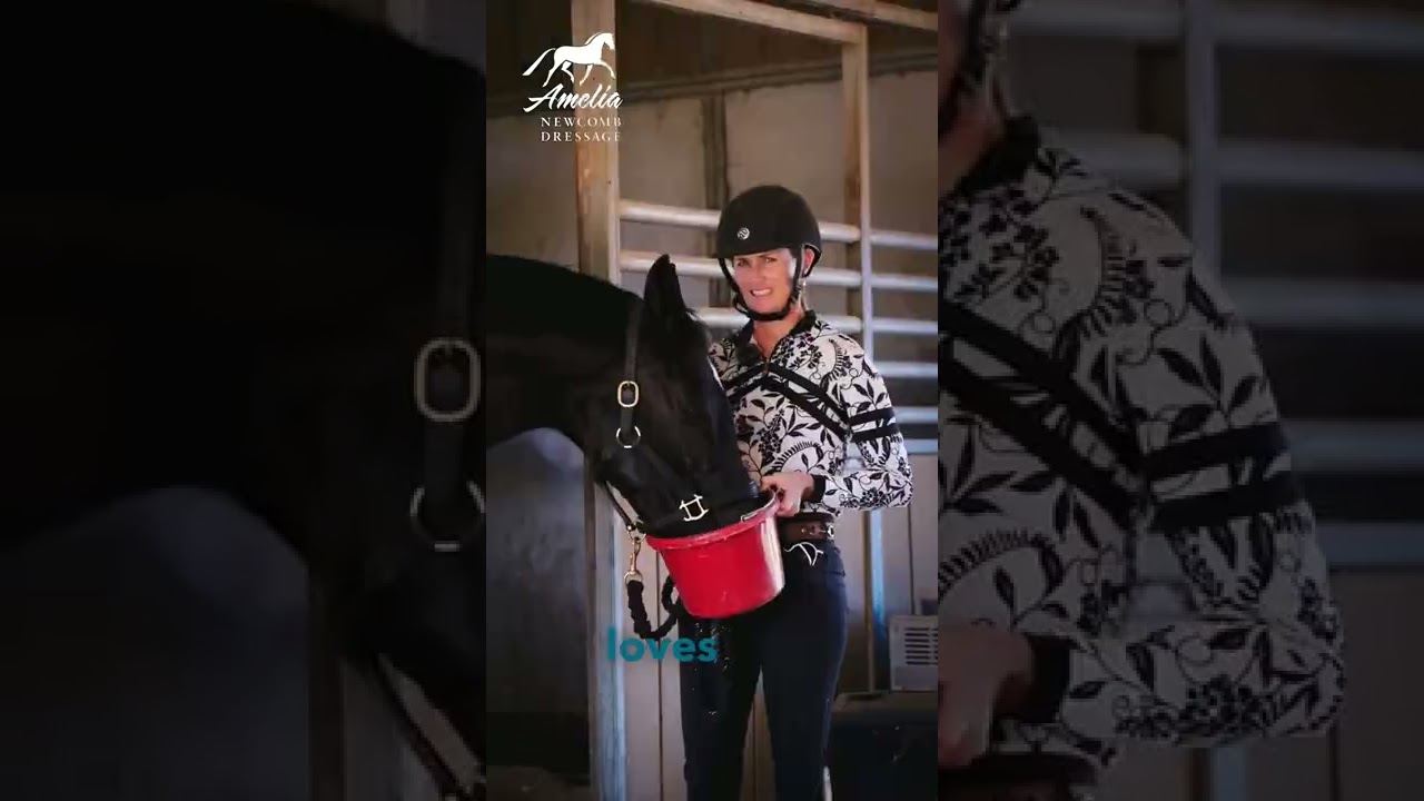A smiling person in a helmet and patterned shirt holds a red feed bucket for a black horse inside a stable. The horses head is lowered into the bucket. Text and a logo are visible on the image.