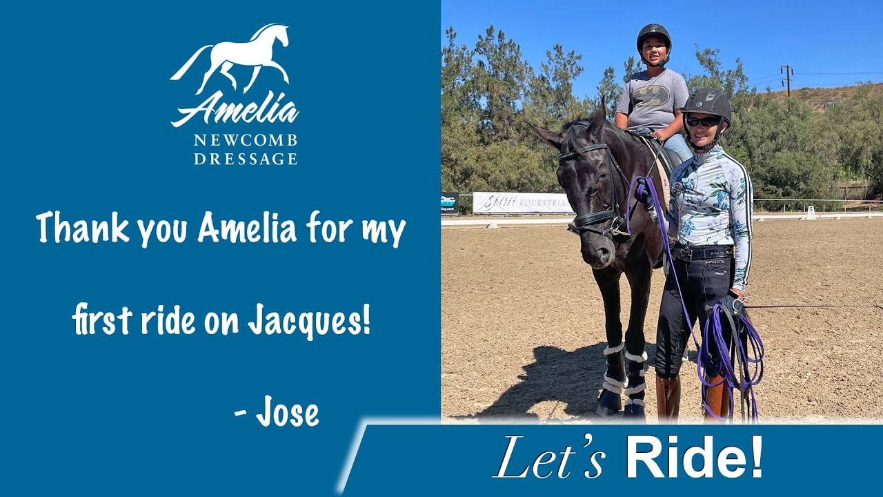 A smiling woman stands beside a black horse ridden by a child, both wearing helmets, on a sandy riding arena. Text thanks Amelia Newcomb Dressage for the ride on Jacques, signed by Jose.