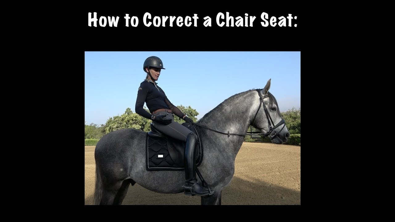 A person in riding gear demonstrates incorrect chair seat posture while sitting on a gray horse in an outdoor arena, with text above reading How to Correct a Chair Seat:.