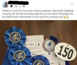Three blue equestrian award ribbons, a USDF medal, and competition number 150 are arranged on dressage test sheets. This Elementor Loop Item highlights a successful first show in a celebratory social media post.