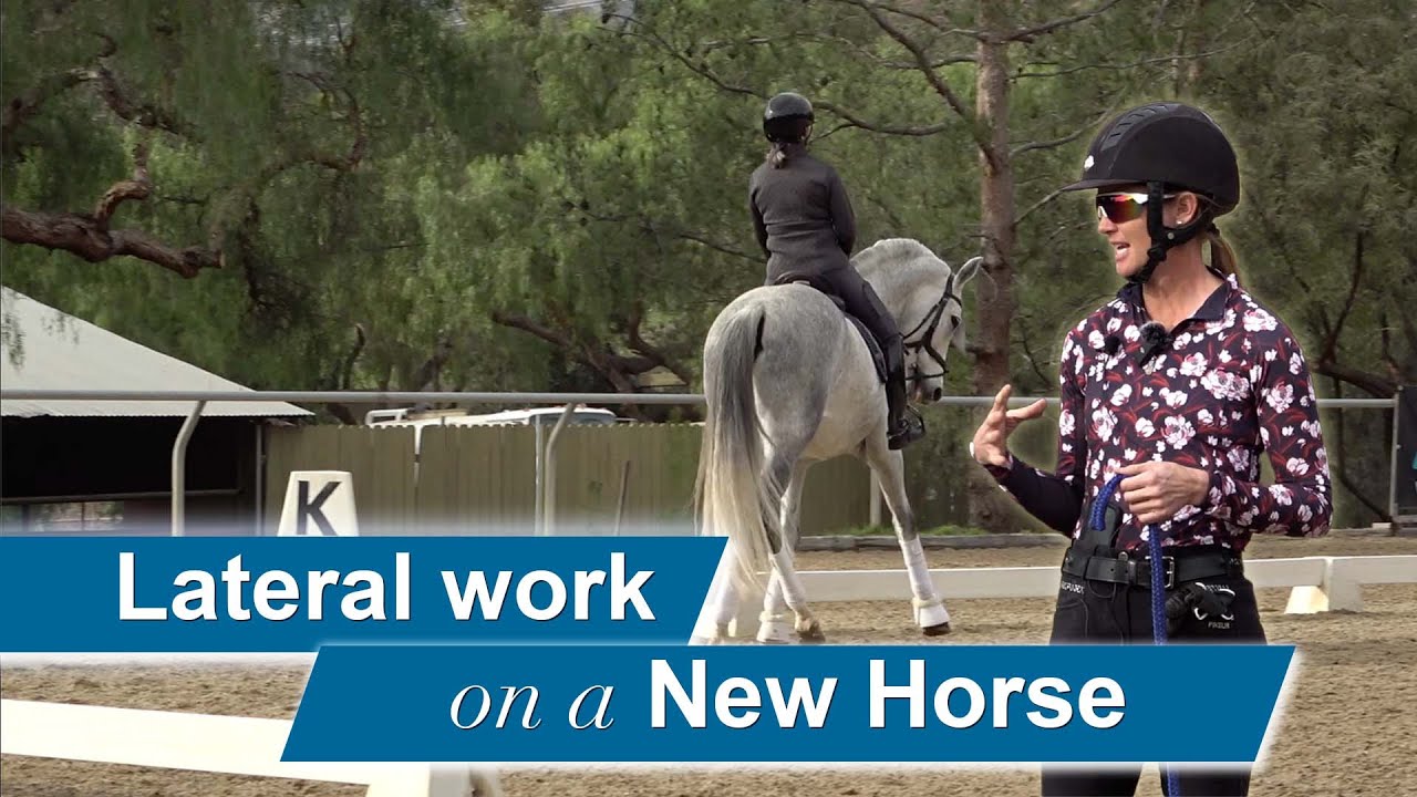 A woman in a helmet and sunglasses discusses horse training on camera in an outdoor riding arena, while another person practices lateral work with a new horse in the background. Text reads, Lateral work on a New Horse.