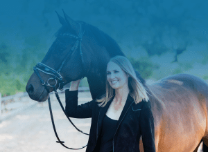 A woman with blonde hair smiles while standing next to a dark brown horse, holding its bridle. Subtle patterns blend into the slightly blurred outdoor background with a blue gradient overlay at the top.