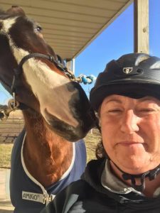 Online student GinaLee posing with her horse.