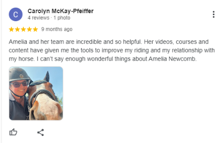 A woman wearing a helmet smiles and poses next to a horse outdoors. The review above praises Amelia and her team for helpful videos like the Sitting Trot Challenge, which improved the reviewer’s riding skills and relationship with her horse.