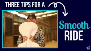 A smiling person in a patterned shirt and hat holds a large white saddle pad shaped like butterfly wings. Text reads, Three tips for a better ride, with an arrow pointing to the words.