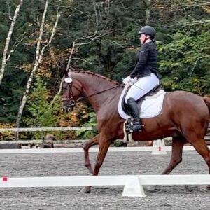 Online student Nylah competing her horse in a dressage competition.