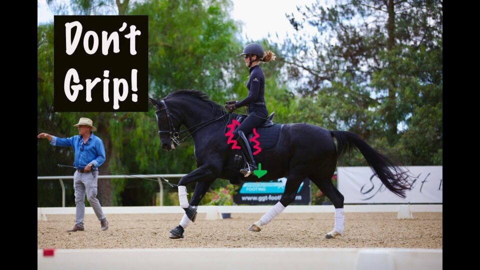 A woman in riding gear practices dressage at the canter on a black horse in an outdoor arena, while an instructor walks beside them. Text reads Don't Grip! with arrows highlighting posture and riding tips about not gripping with your legs.